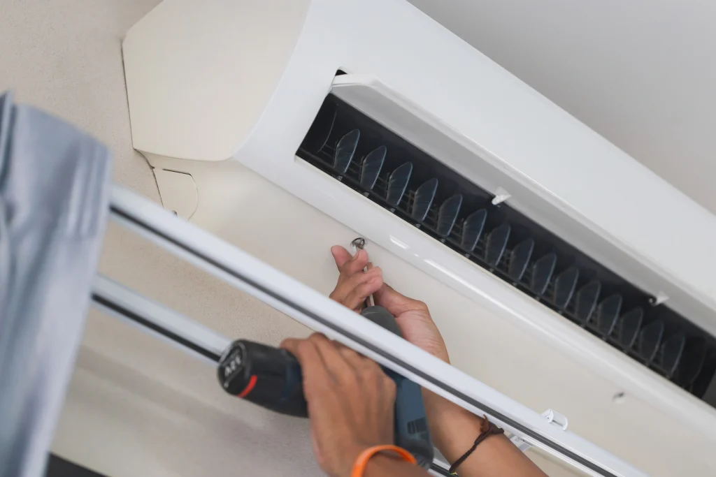 Male technician installing an AC Unit