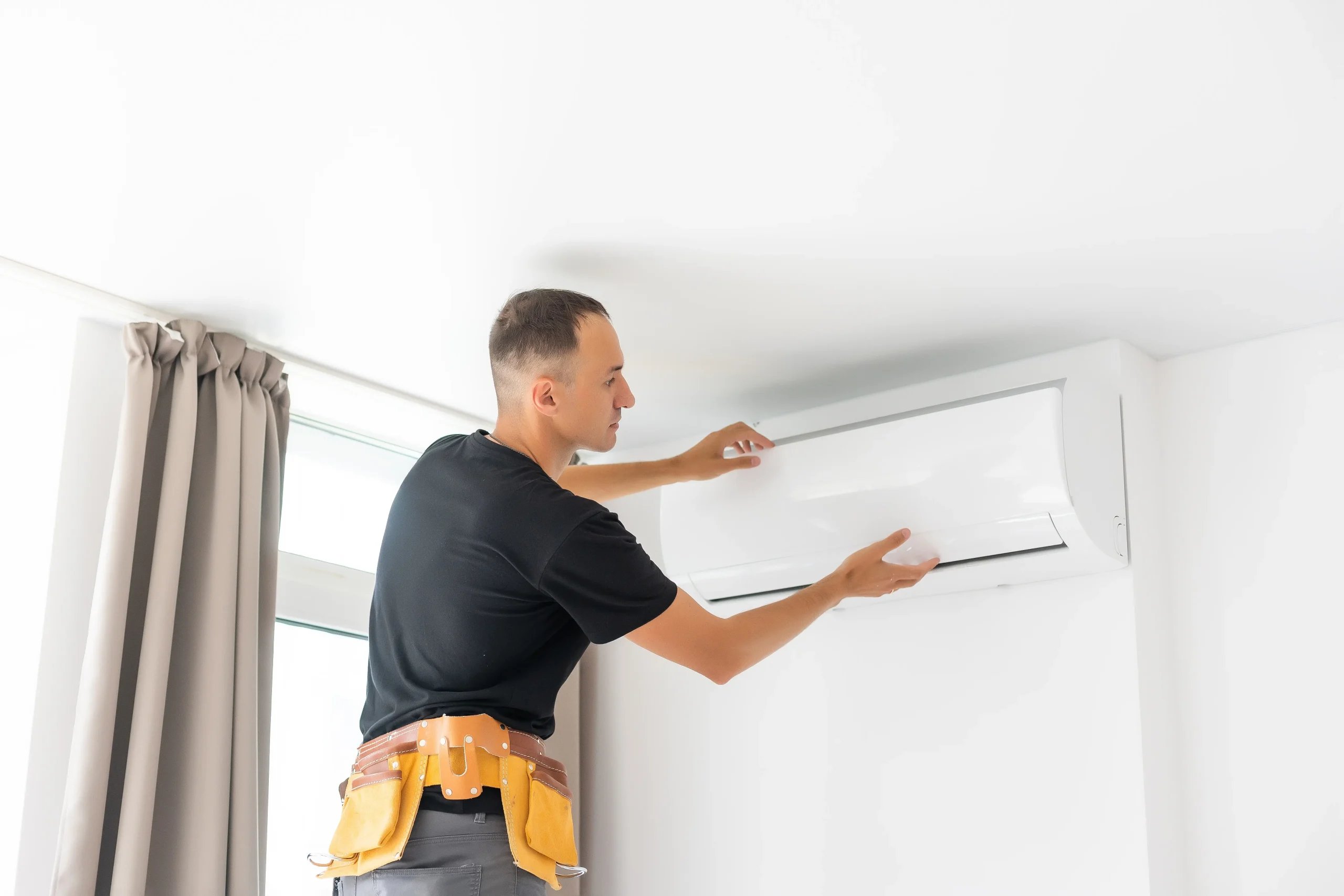 Man Installing Air Conditioning System