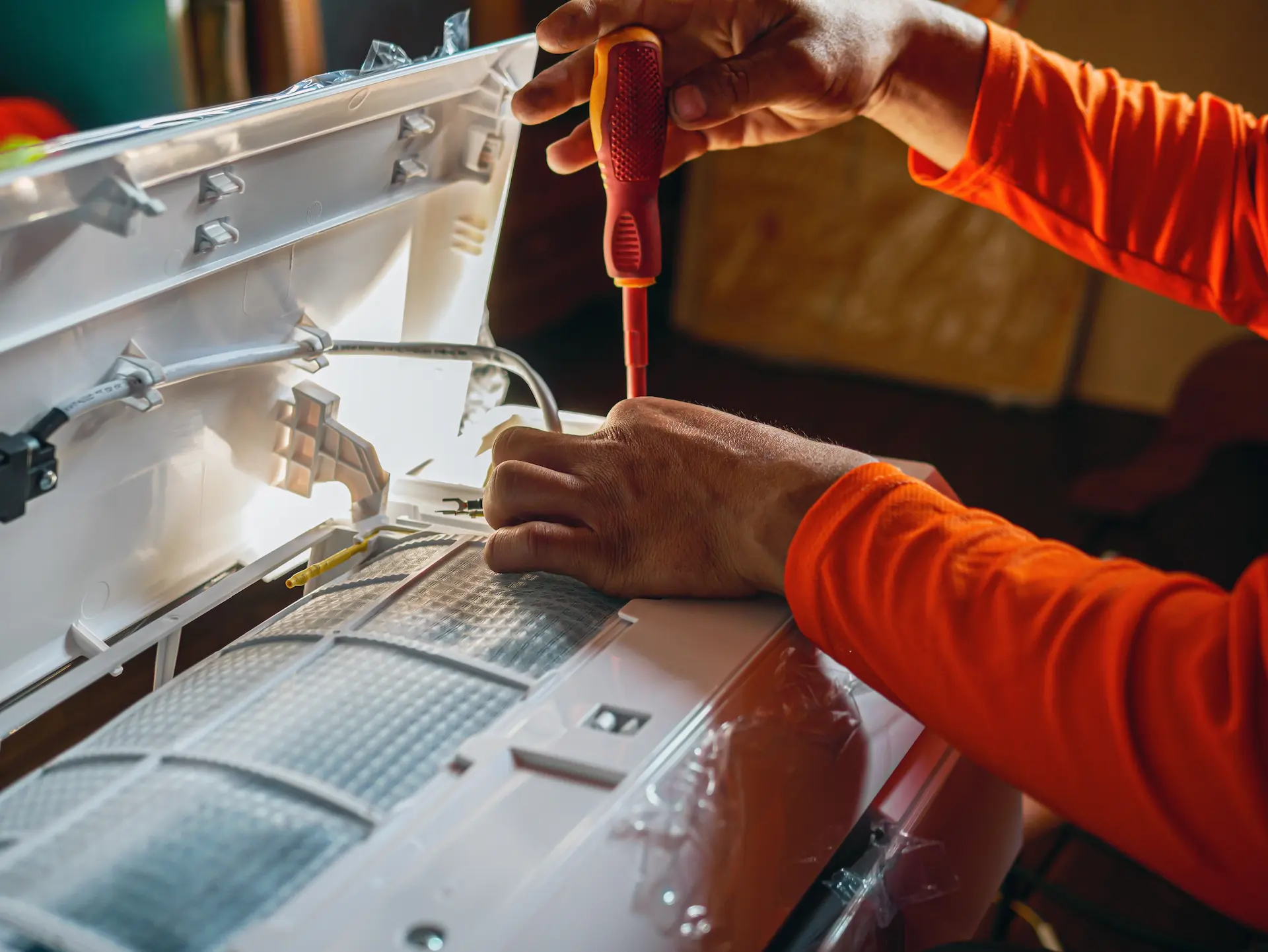 Air conditioning technician prepares to install a new air conditioner