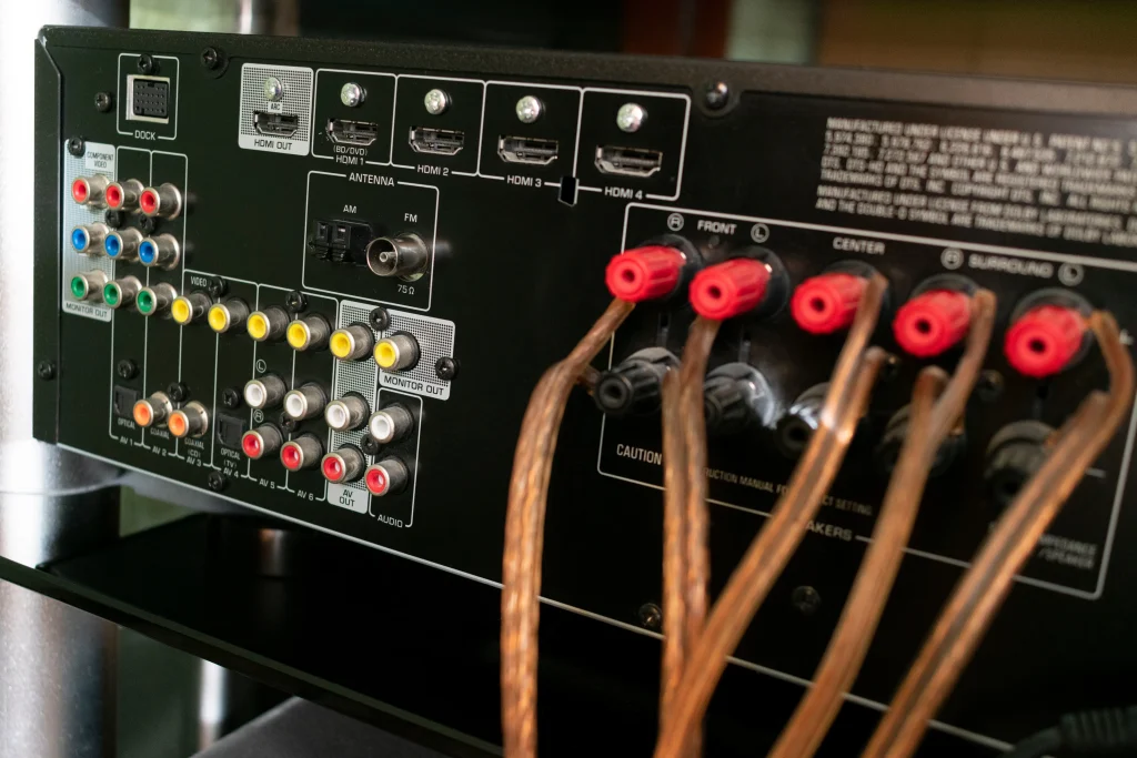 back of audio receiver video for home theater with inputs for connecting equipment and output to speakers with terminals and wires