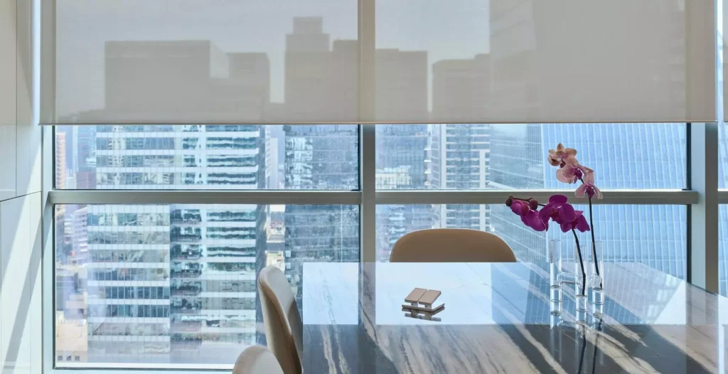 mid-open Lutron Shades overlooking buildings